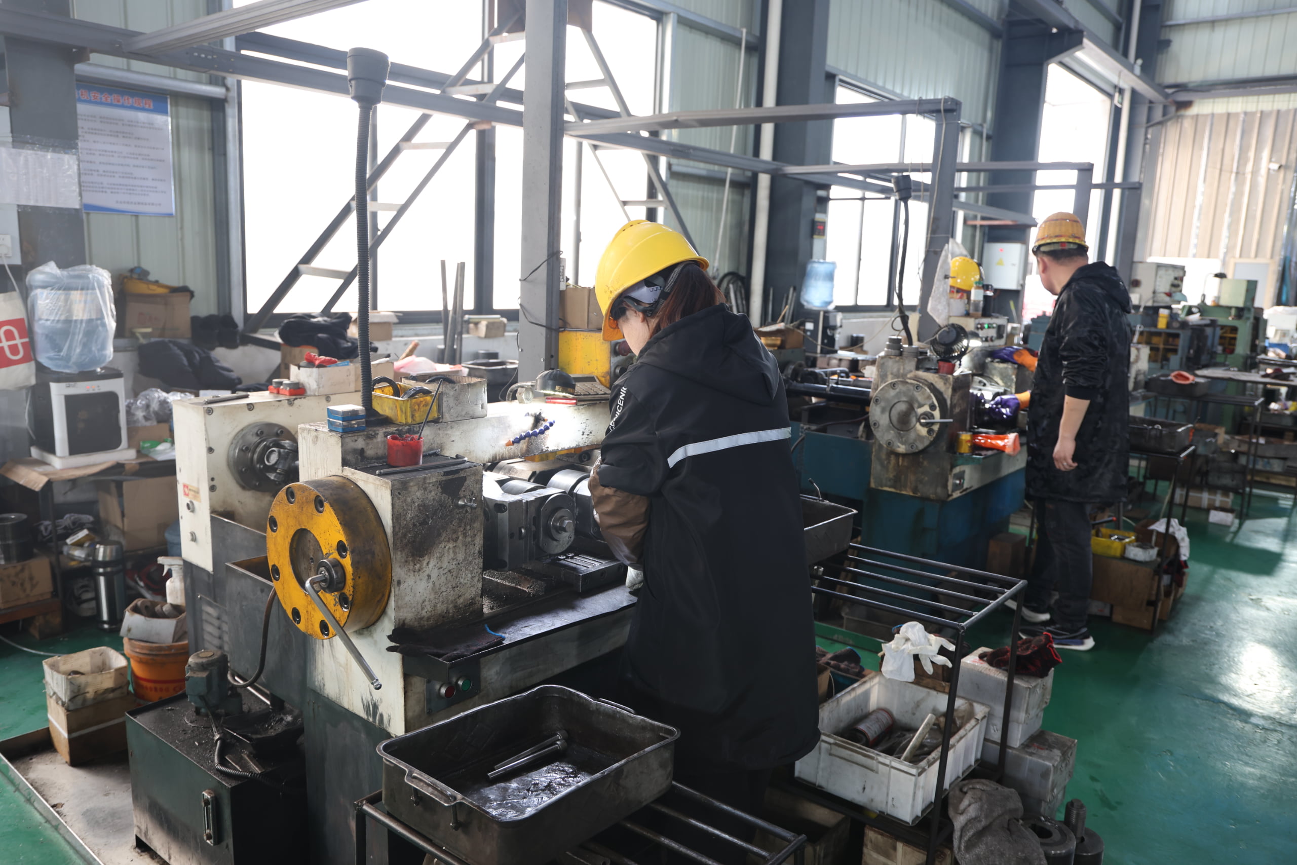 Workers operating machining equipment